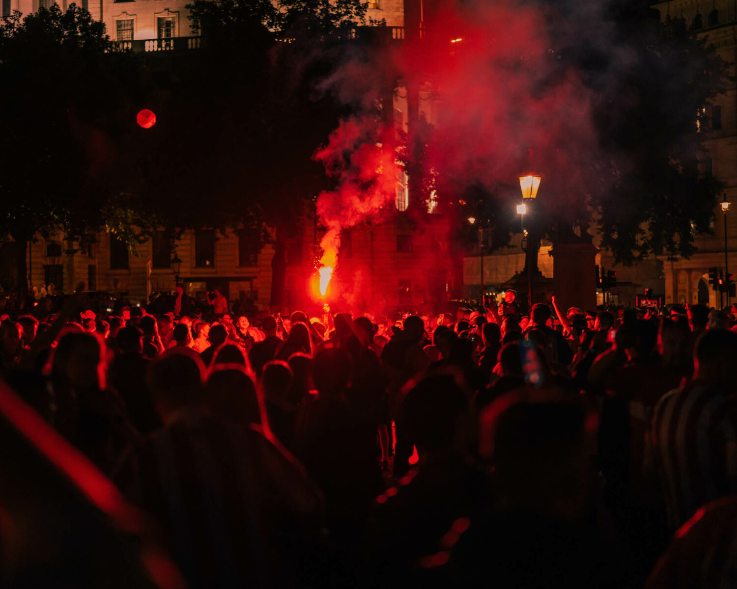 Photography by Joshua K. Jackson. Protestesters releasing red flares.