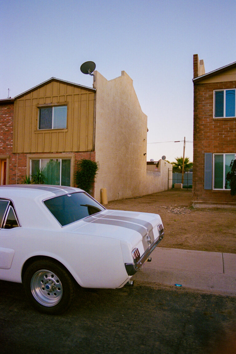 Color, film photography by Jakob Lilja-Ruiz. A white car and colorful houses