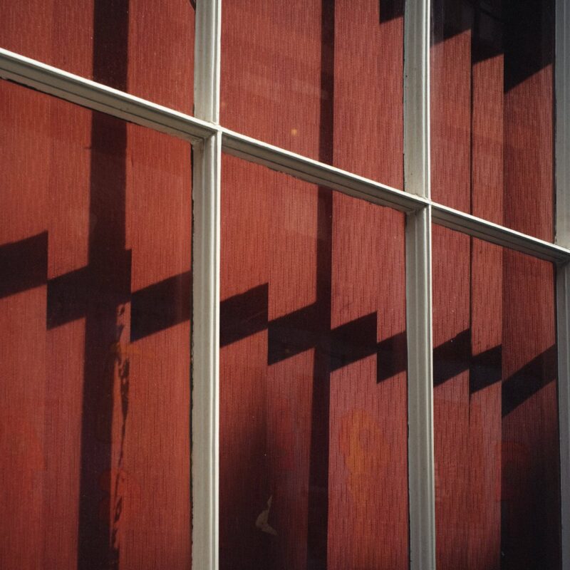 Photography by Phil Sharp, shadows on red curtains