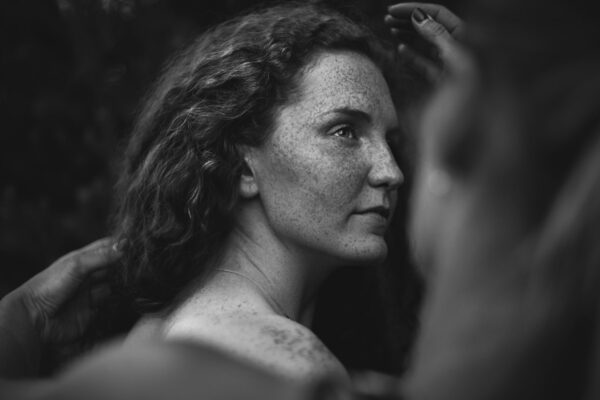 black and white portrait photo of a woman with freckles by Rafal Lapszanski