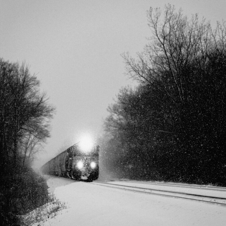 Black & white landscape photography by Adrian Vila. Train in the snow.