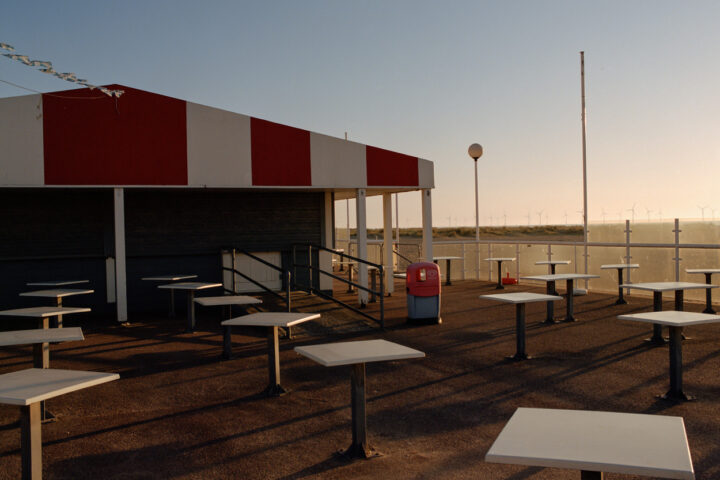 Color photography by Ian Howorth. Sunset on a terrace of beachside cafe/diner