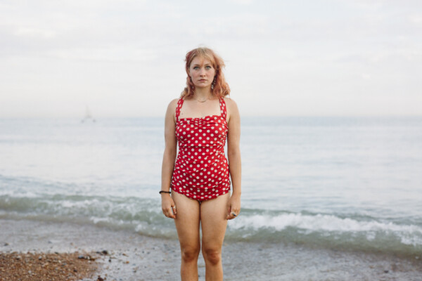 color medium format film portrait of a woman wearing bathing sun by the sea by Andreas Bleckmann