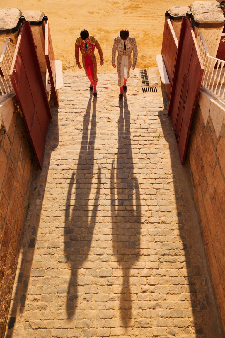 Photo of two bullfighters from above leaving the arena