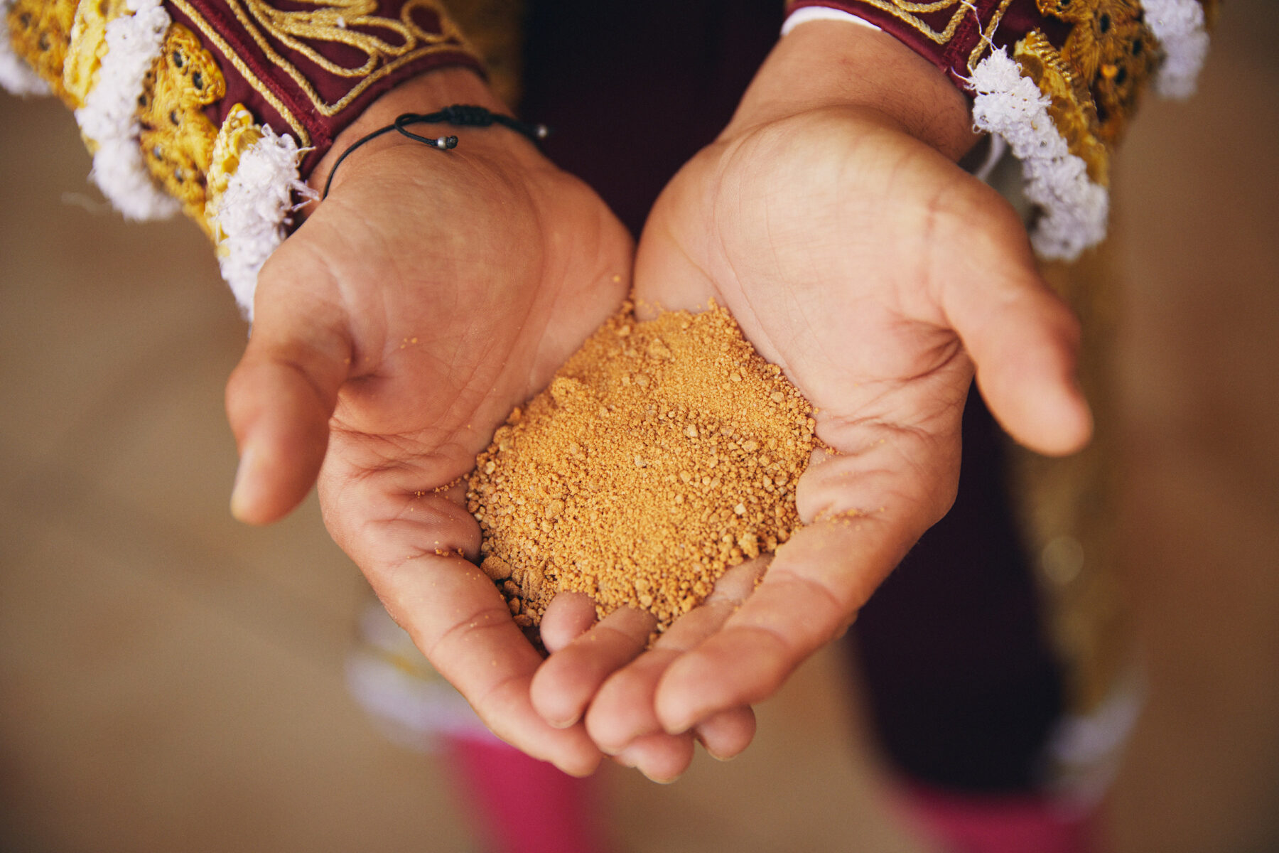 Photo of a bullfighter's hands holding sand