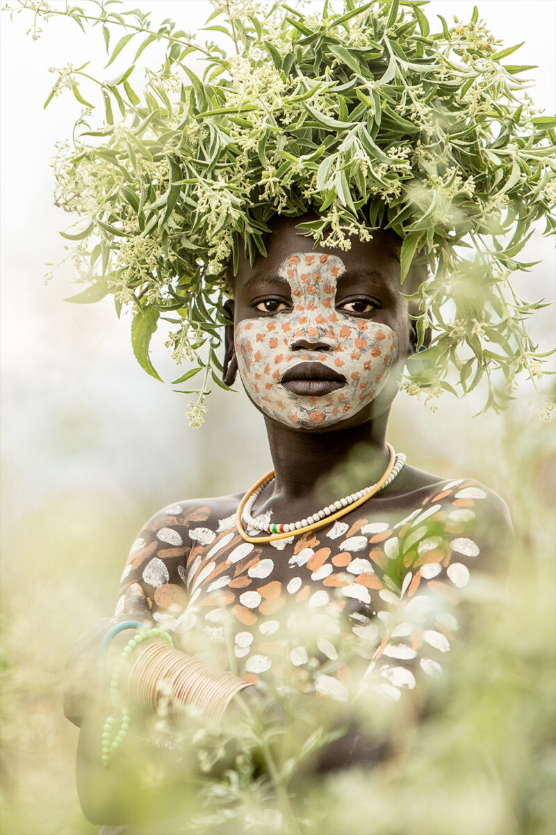 color portrait of a young girl from suri tribe in Ethiopia by Giovanna Aryafara