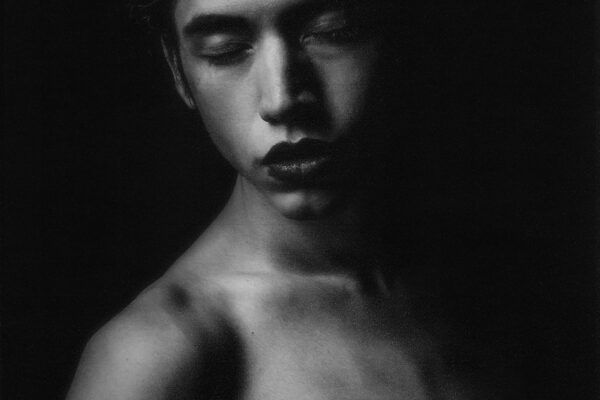 black and white studio portrait of a young man by Zoë Chiara