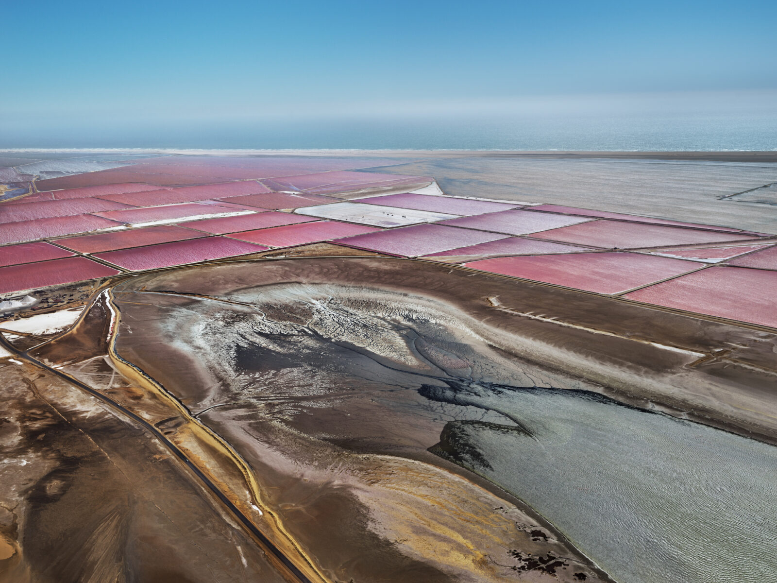 Aerial landscape photography by Edward Burtynsky. Colorful Salt pans in Walvis Bay, Namibia