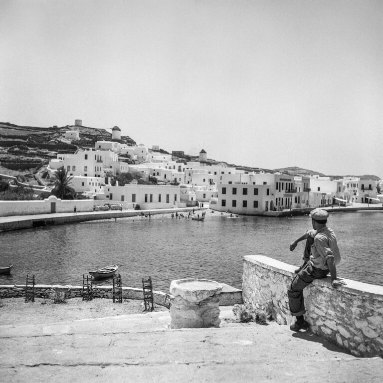 Black & white photography of Greece by Robert McCabe - Man overlooking harbour