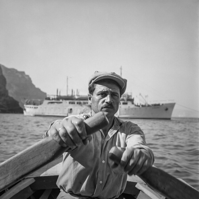 Black & white photography portrait of man rowing boat by Robert McCabe