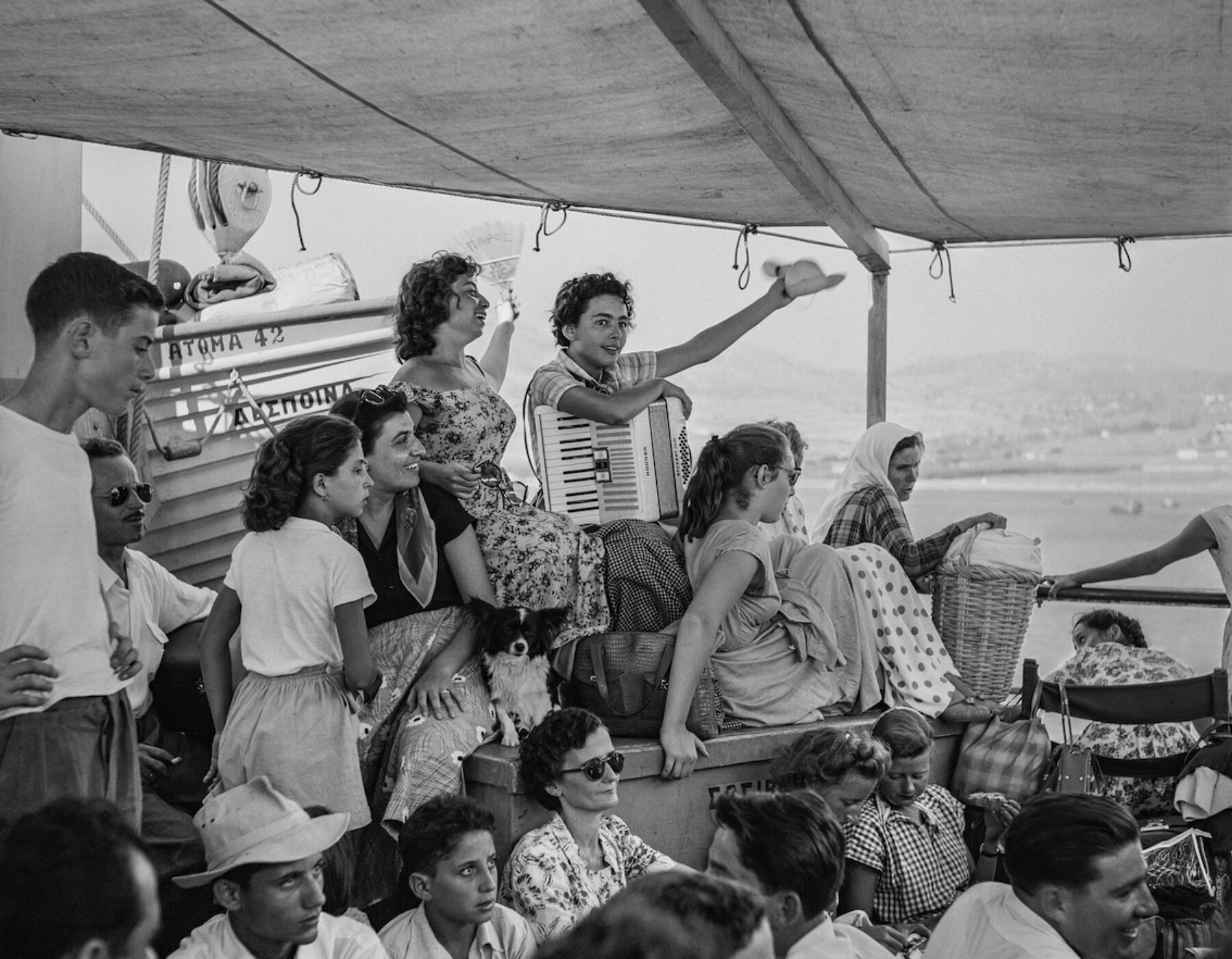 Black & white photography by Robert McCabe, people aboard a boat in Greece