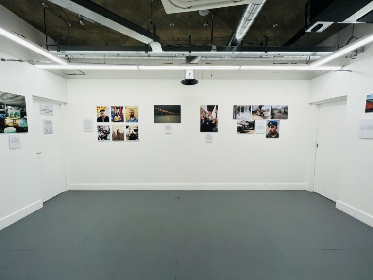 Photo of an exhibition space with photos on the wall