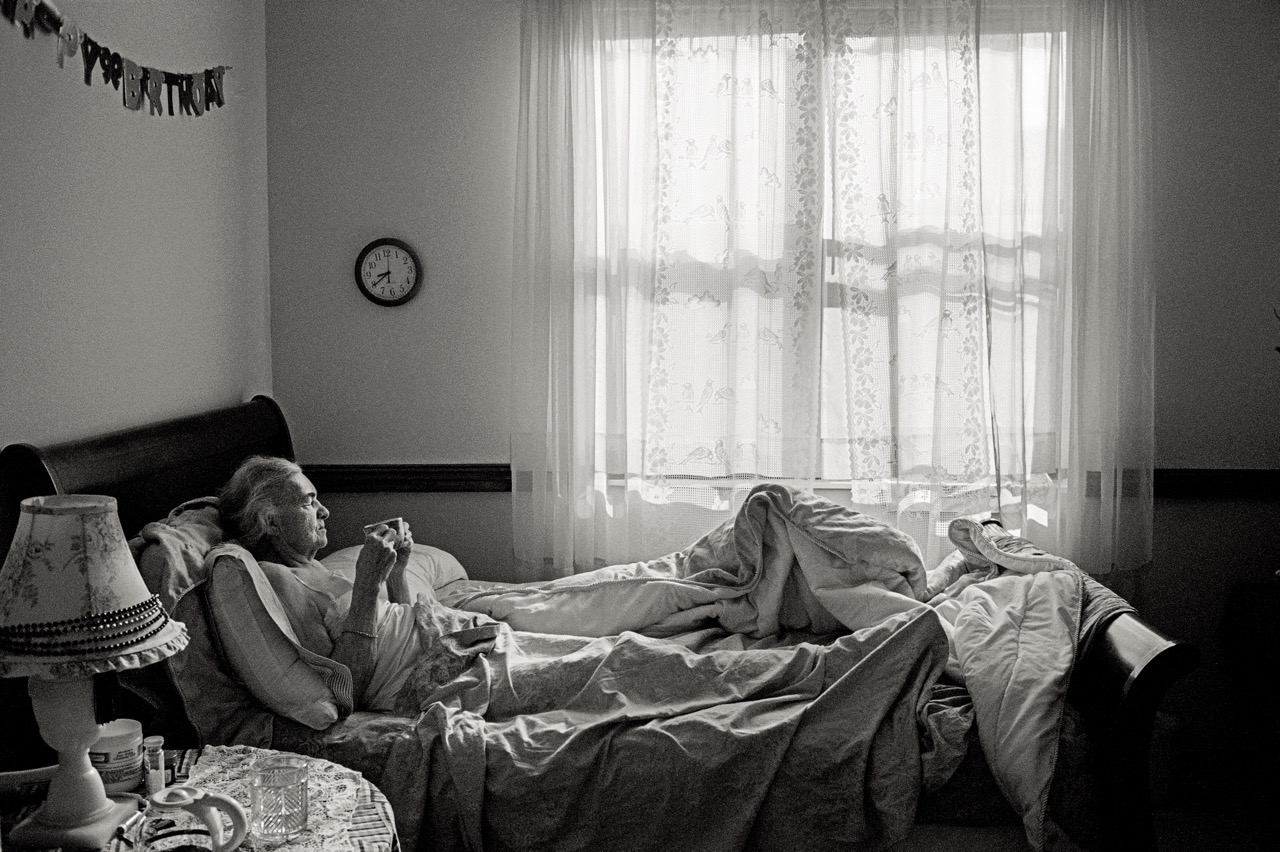 B&W photo of an elderly woman in bed