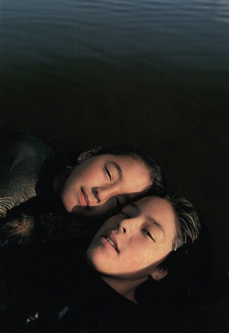 Portrait photo of two native american girls swimming in Canada