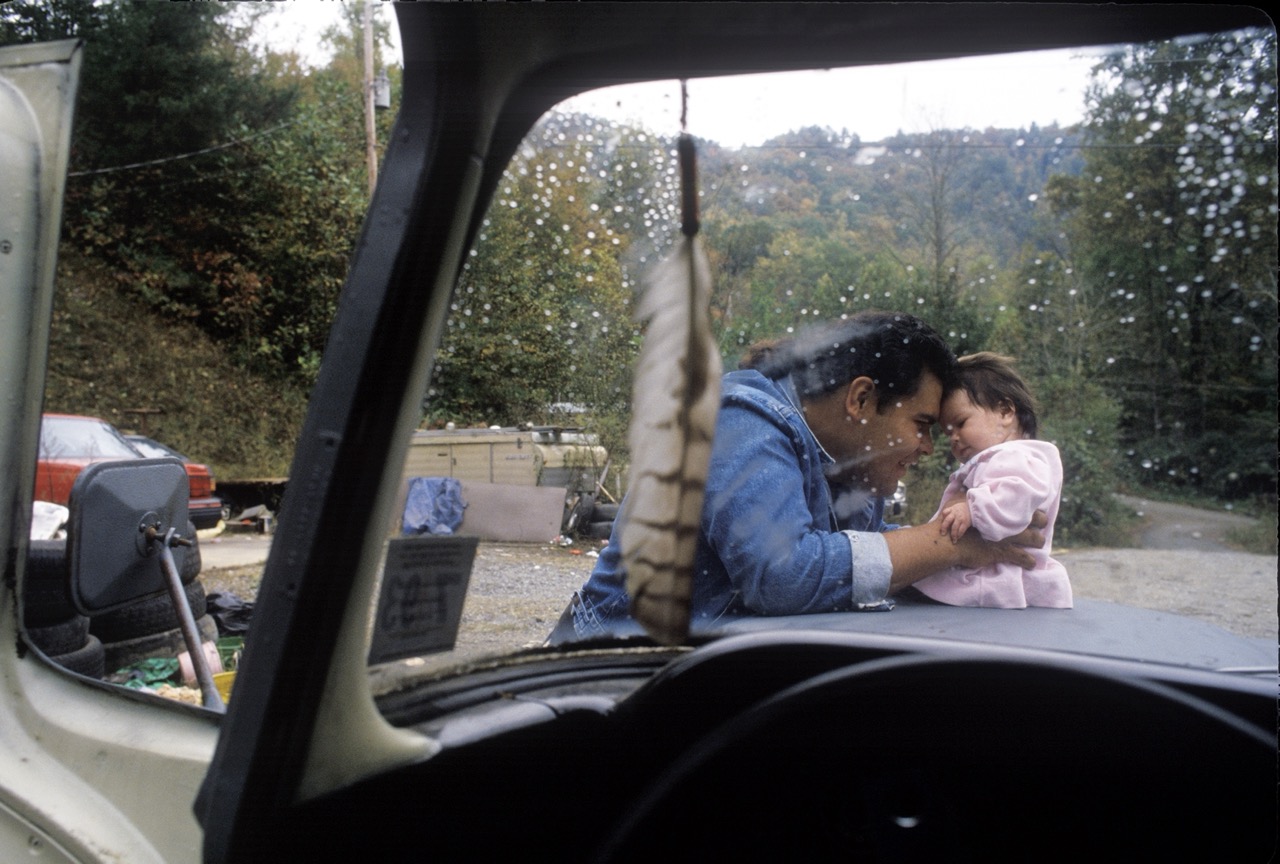 Photo of a Cherokee man embracing his daughter by Maggie Steber