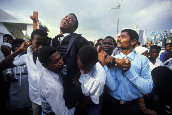 A young man crying for his dead mother in Haiti