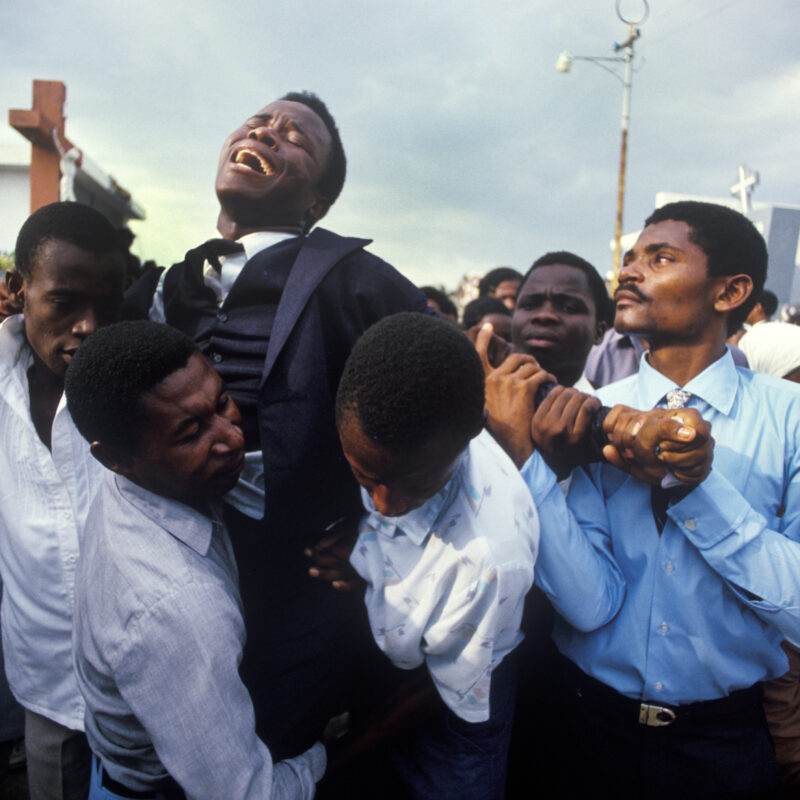 A young man crying for his dead mother in Haiti