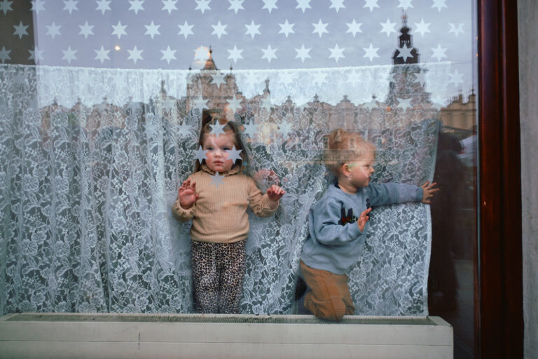 Street photography by Eduardo Ortiz. Two young children in a window