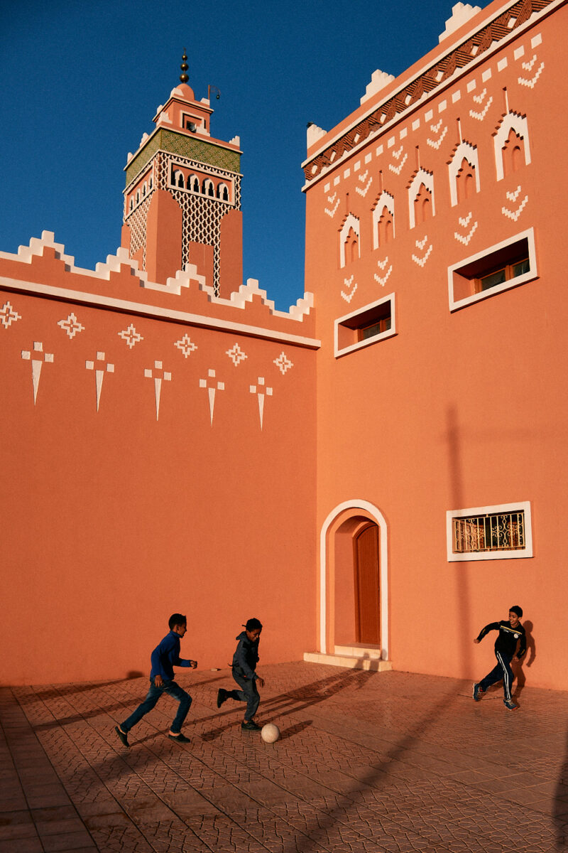 Street photography by Eduardo Ortiz. Boys playing football in Morocco