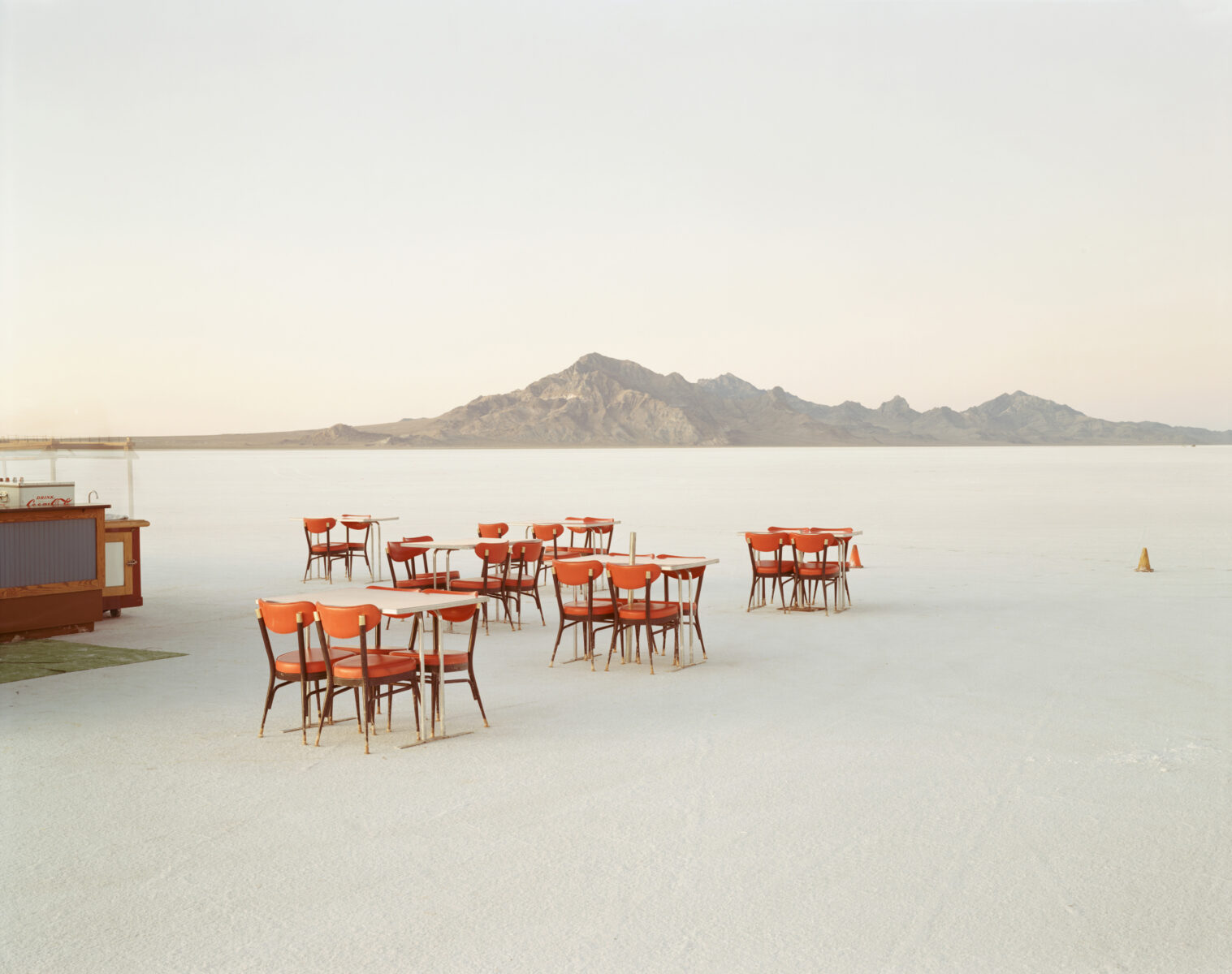 Photo of orange chairs and white tables on a salt flat