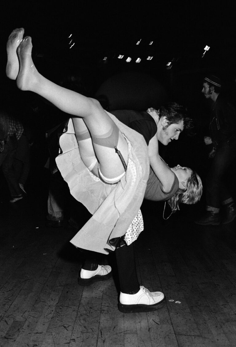 Black & white photo of two people dancing in 1976 by Chris Steele Perkins. From the book England My England