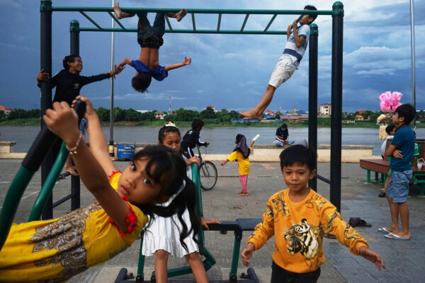 color street photo of children in playground in Cambodia by Greg Mo