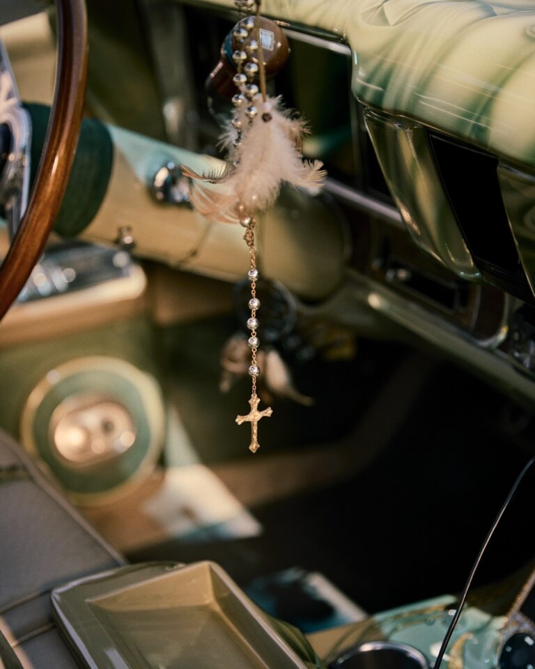 Documentary photography by Owen Harvey. Rosary beads and crucifix hanging from a car dashboard. From the project Ground Clearance LA