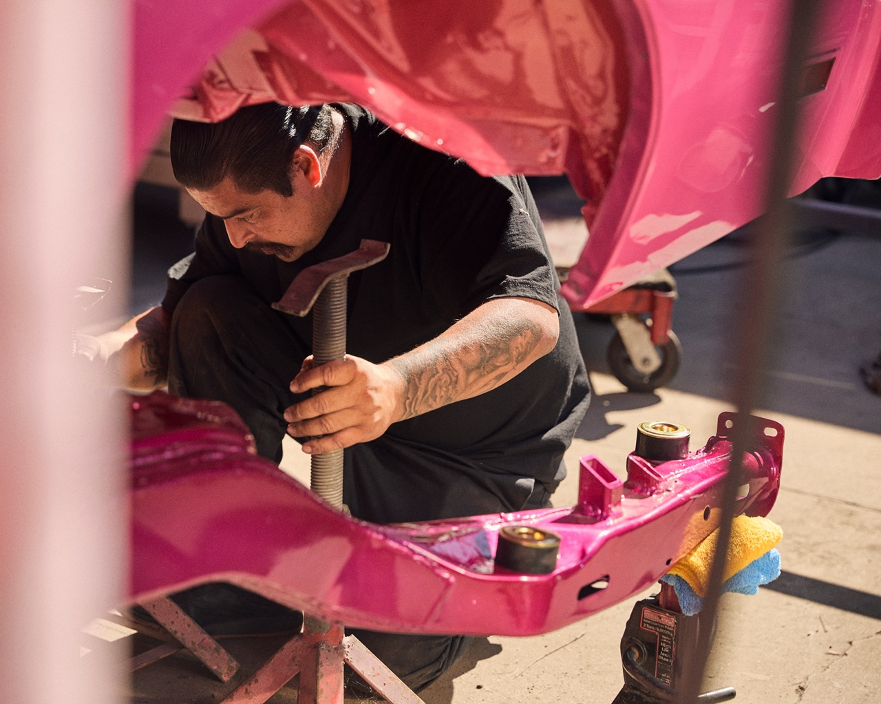 Documentary photography by Owen Harvey. Man fixing car. From the project Ground Clearance LA