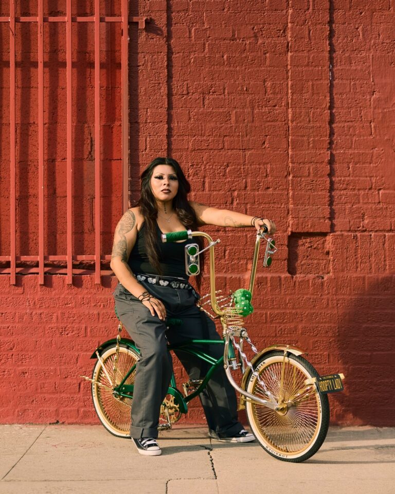 Documentary photography by Owen Harvey. portrait of a tattooed girl on a bicycle. From the project Ground Clearance LA