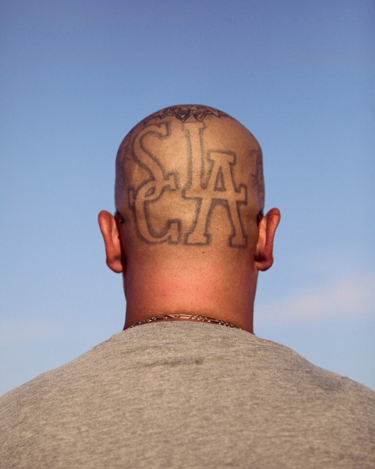 Documentary photography by Owen Harvey. Tattoo on the back of a head.