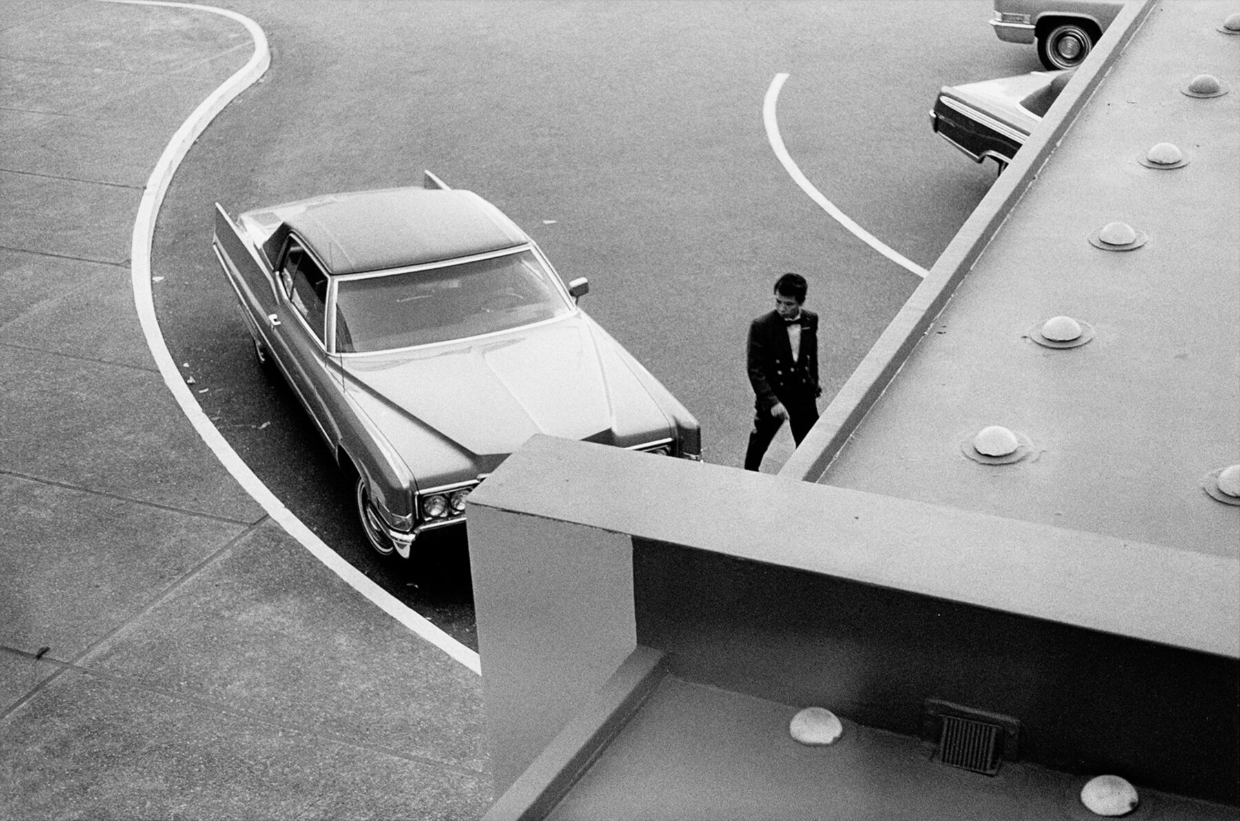 Black & white photography by William Eggleston. Car and man