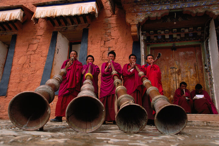 Photo of monks blowing large horns by Michael Yamashita