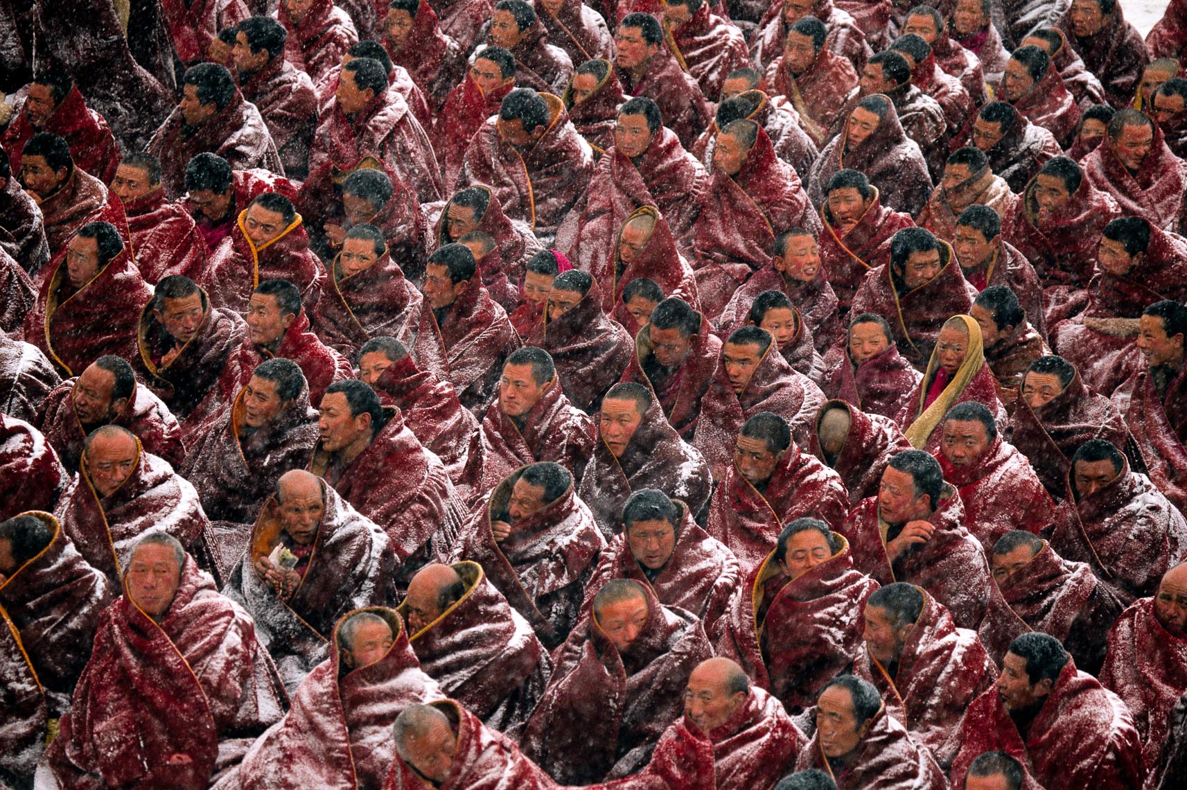 Photography by Michael Yamashita. Monks in a blizzard, Tibet.