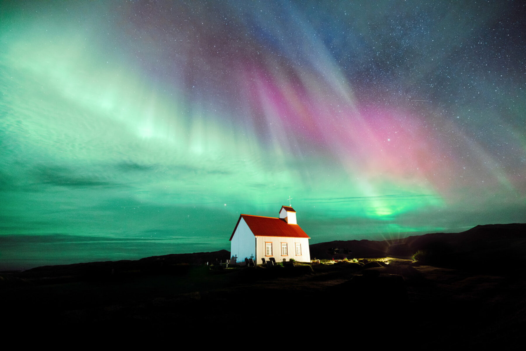 Open Call Award ; color landscape photo of church and northern light in Iceland by Stevie Reinhart