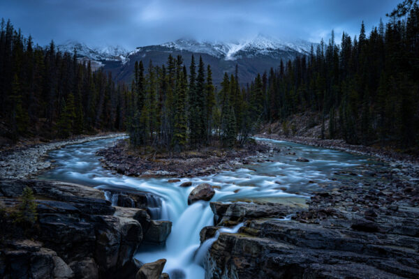 color landscape photo of mountains and river in Rocky Mountains, Canada by Leighton Lum