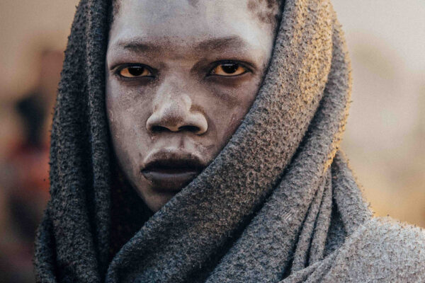 color portrait photo of a young Mundari boy in south sudan by Frances Bruchez