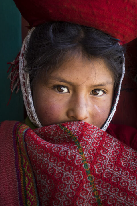 Portrait of a Pervuvian schoolgirl shot in Huilloc, Peru by Ron Cooper