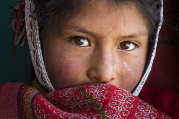 Portrait of a Pervuvian schoolgirl shot in Huilloc, Peru by Ron Cooper