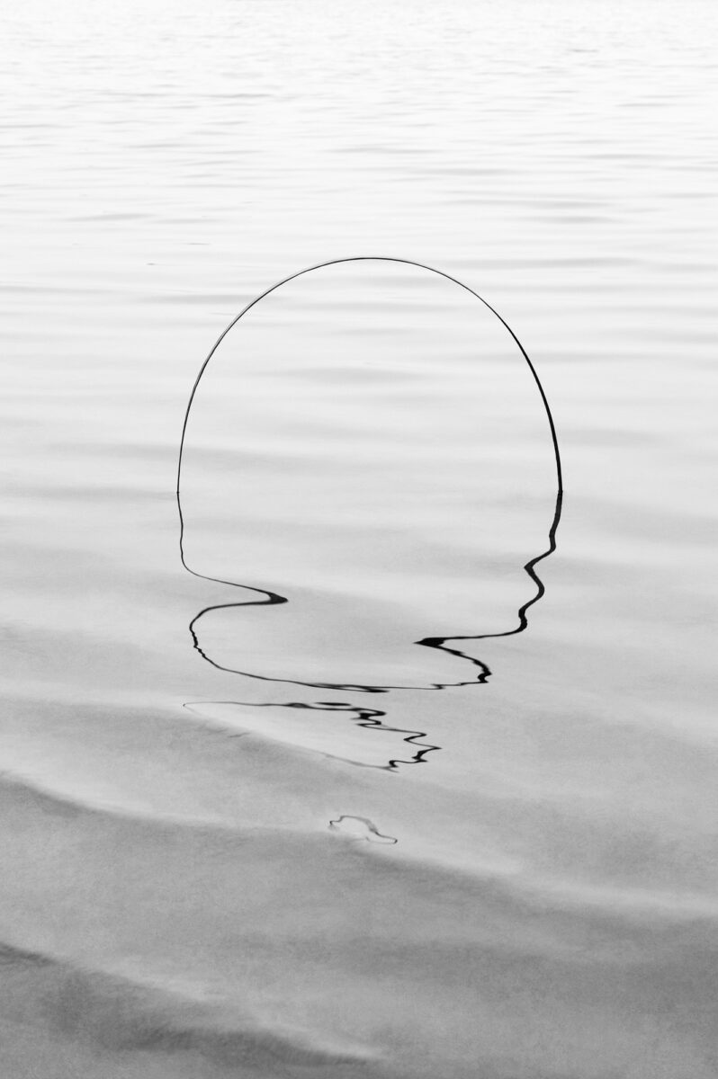 black and white abstract photo of shape in water by Esteban Amaro