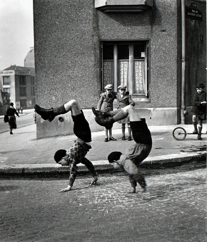 Black and white photo of two boys playing by Robert Doisneau. Paris, France, 1934