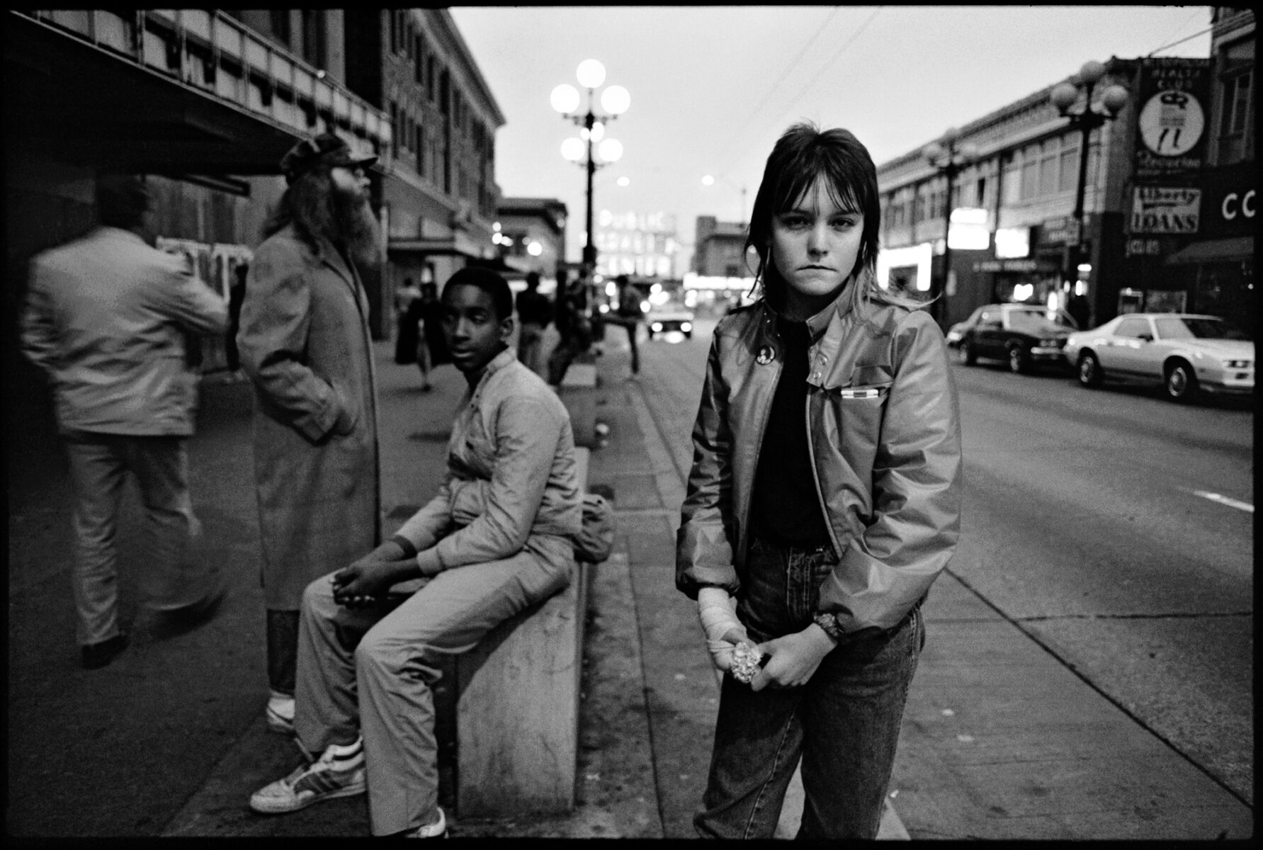 Black and white photo of people in Pike Street, Seattle, 1983 by Mary Ellen Mark