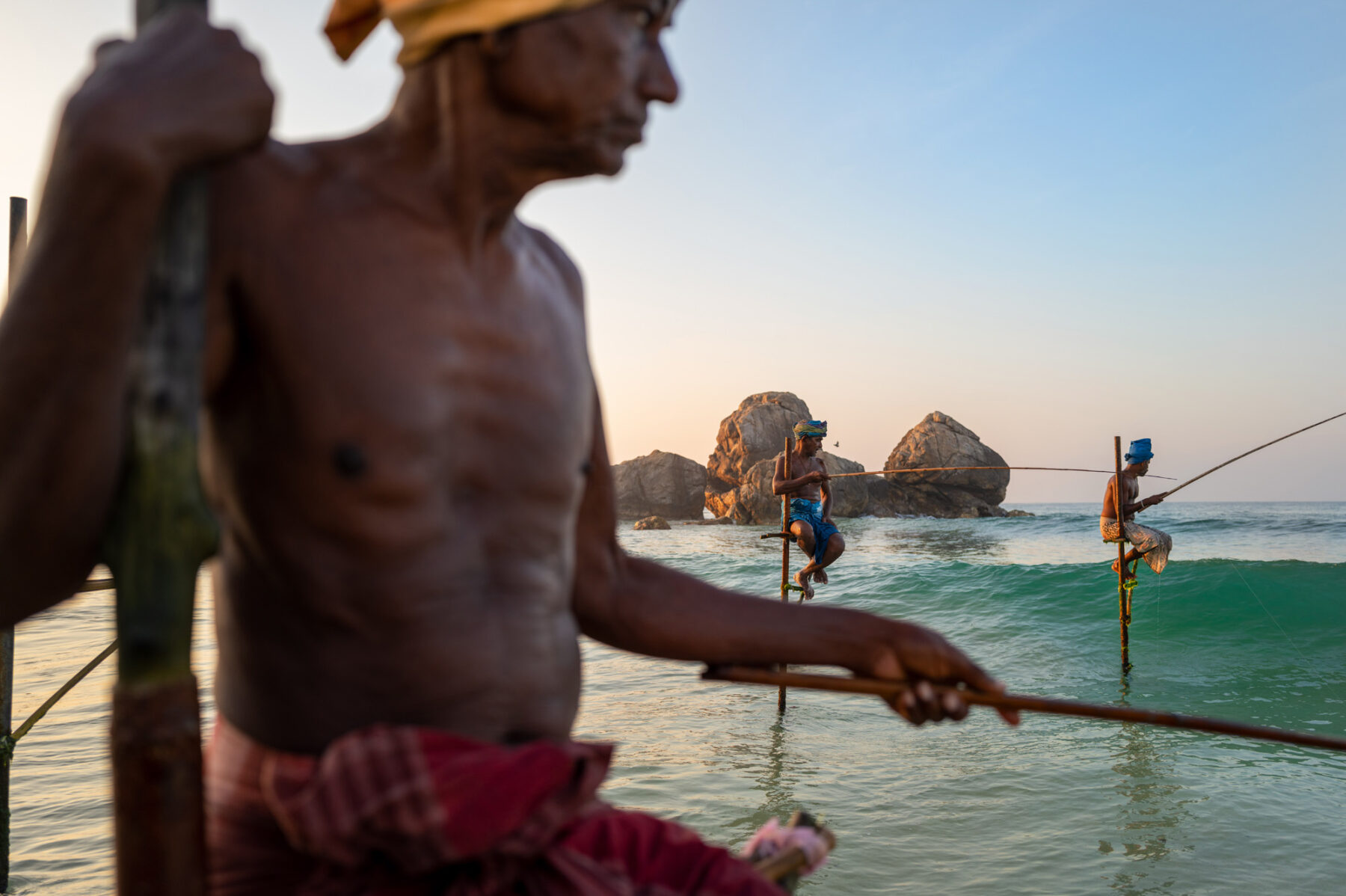 color photo of stilt fishermen in Weligama, Sri Lanka by Andrea Peruzzi