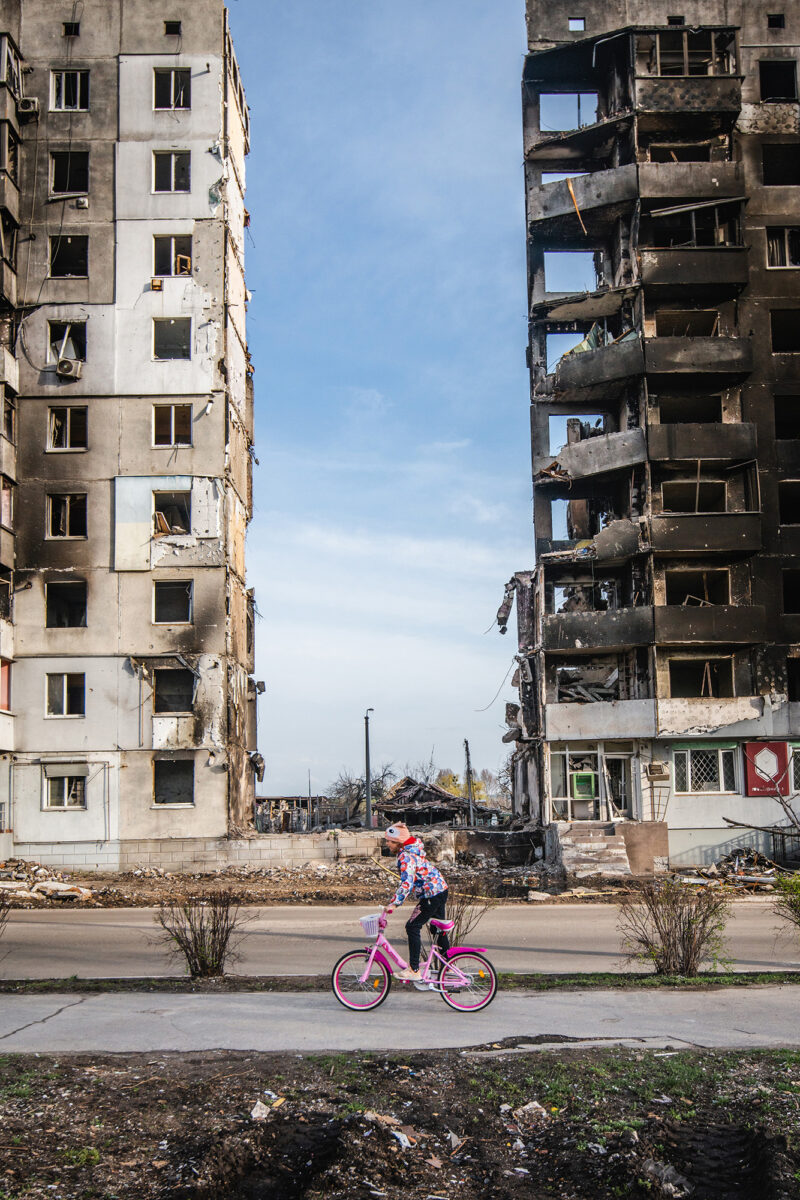 color documentary photo of girl cycling in Borodyanka, Ukraine by Andrii Zabolotnyi