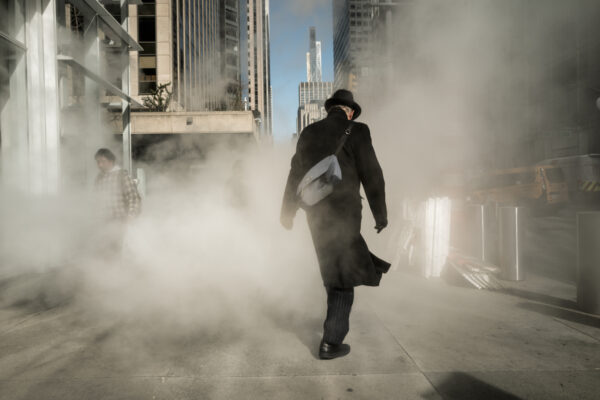 color street photo of man covered in smoke in New York by Bjane Levine