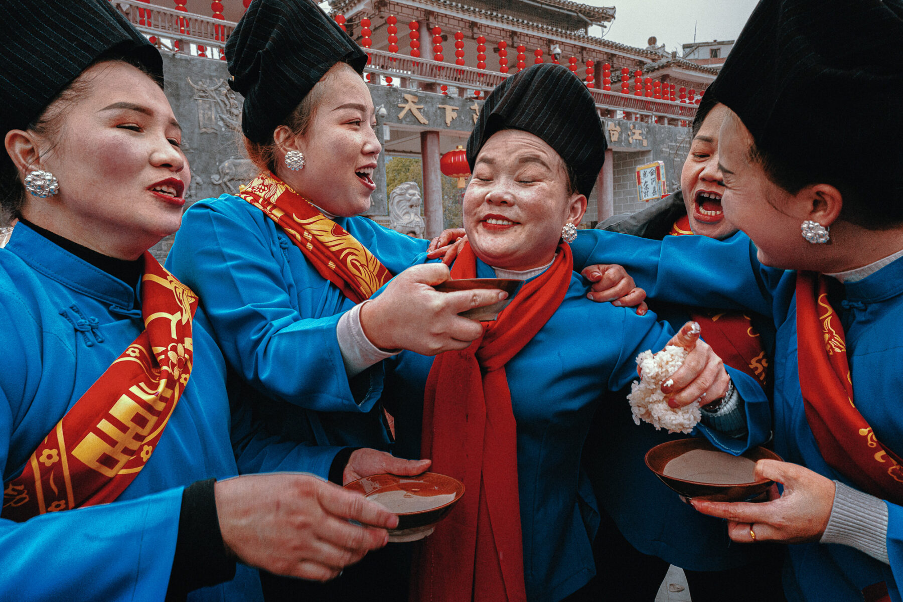 Candid street scene of Miao people celebrating New Year by José Díaz López