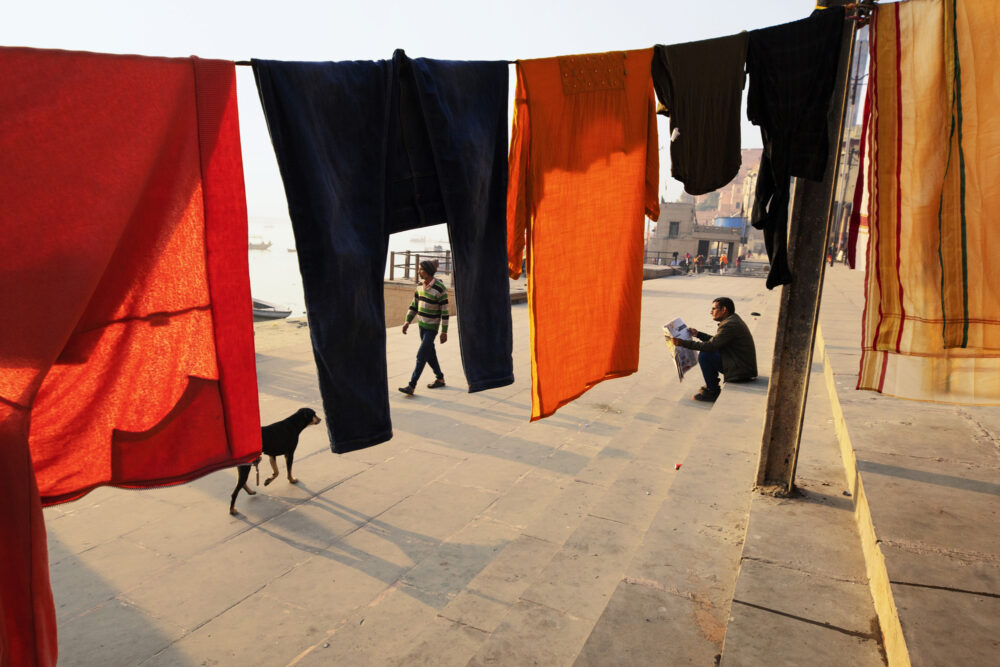 Candid street photo in Varanasi, India at sunrise by Nese Ari